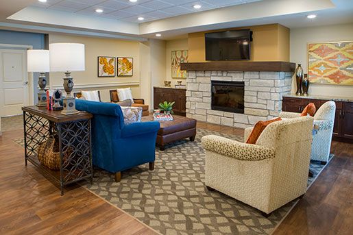 living room with a fire place at The Delaney at Parkway Lakes