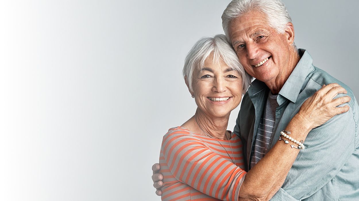 white fade with elderly couple hugging at The Delaney at Parkway Lakes senior living