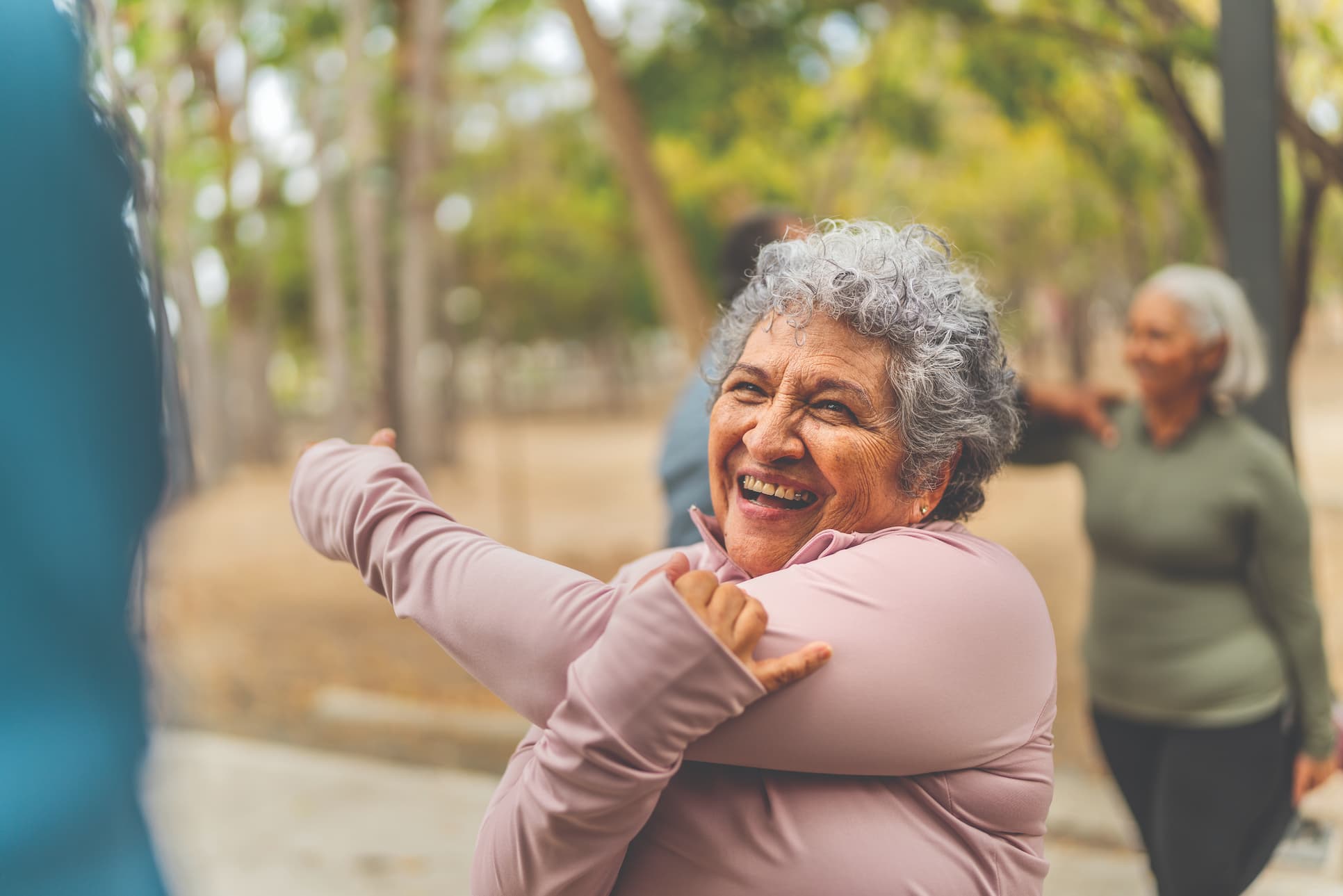 senior woman stretching in outdoor fitness class