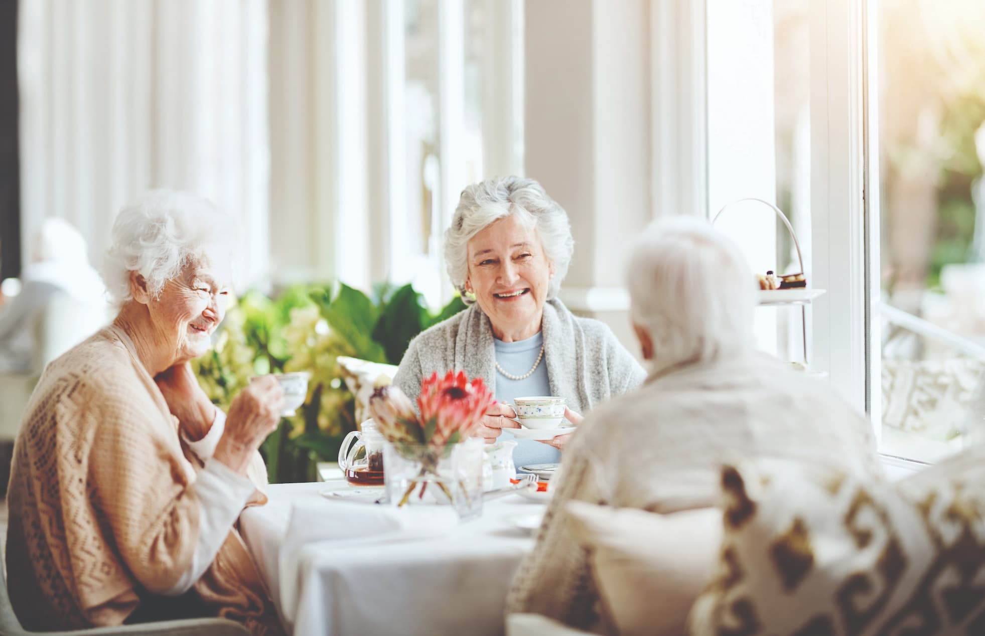 Senior women enjoying tea around a table