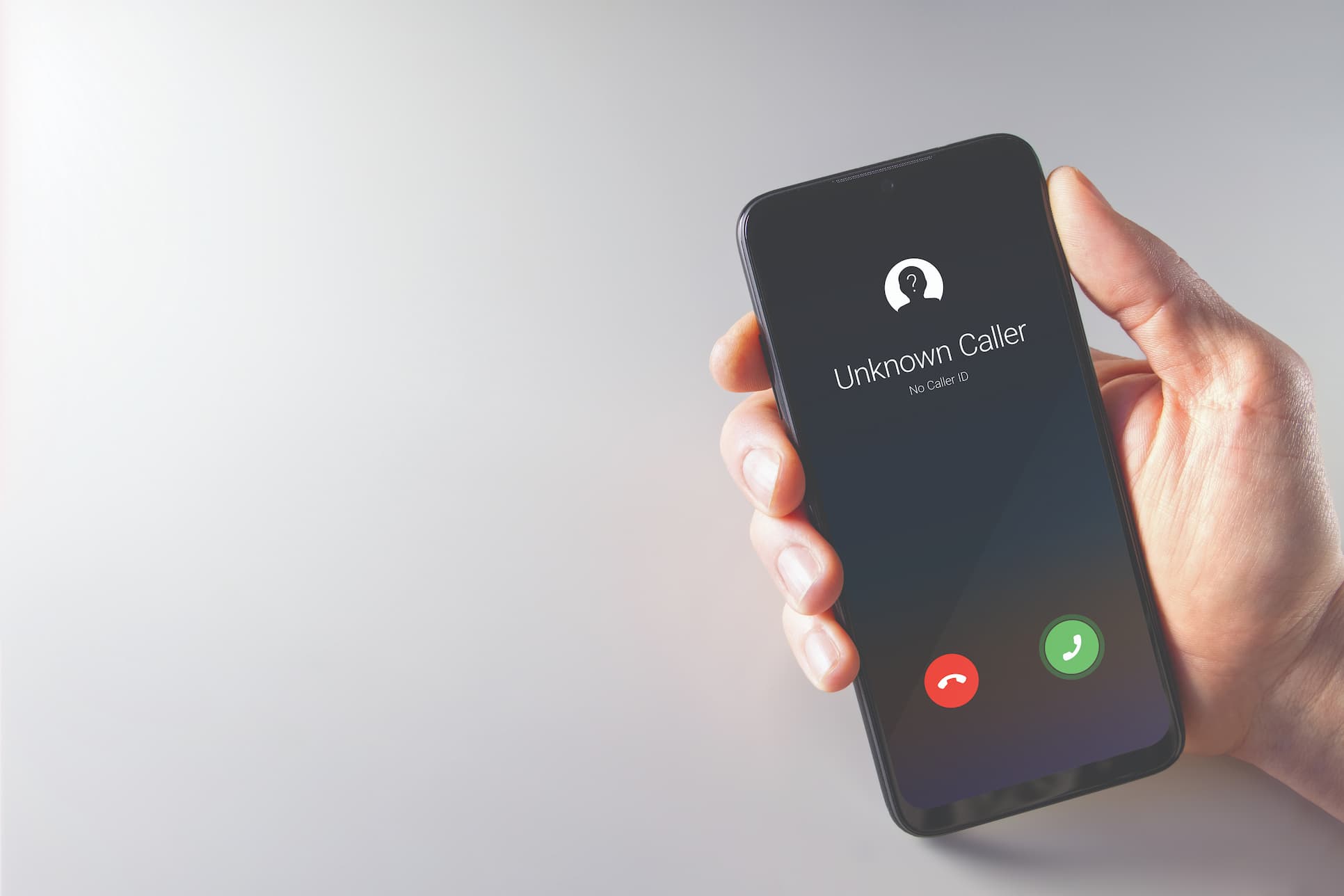Mobile phone with phone call screen showing Unknown Caller id